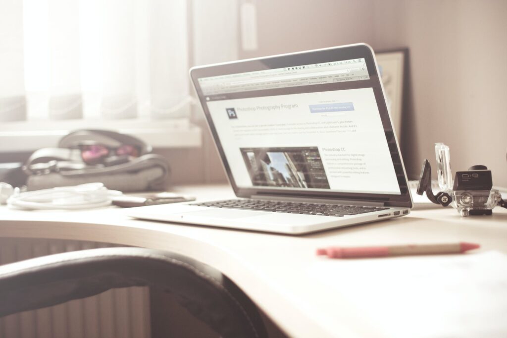 black and gray laptop computer on writing desk