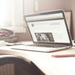 black and gray laptop computer on writing desk