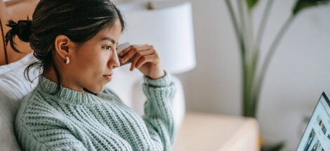 focused young ethnic woman with credit card and laptop